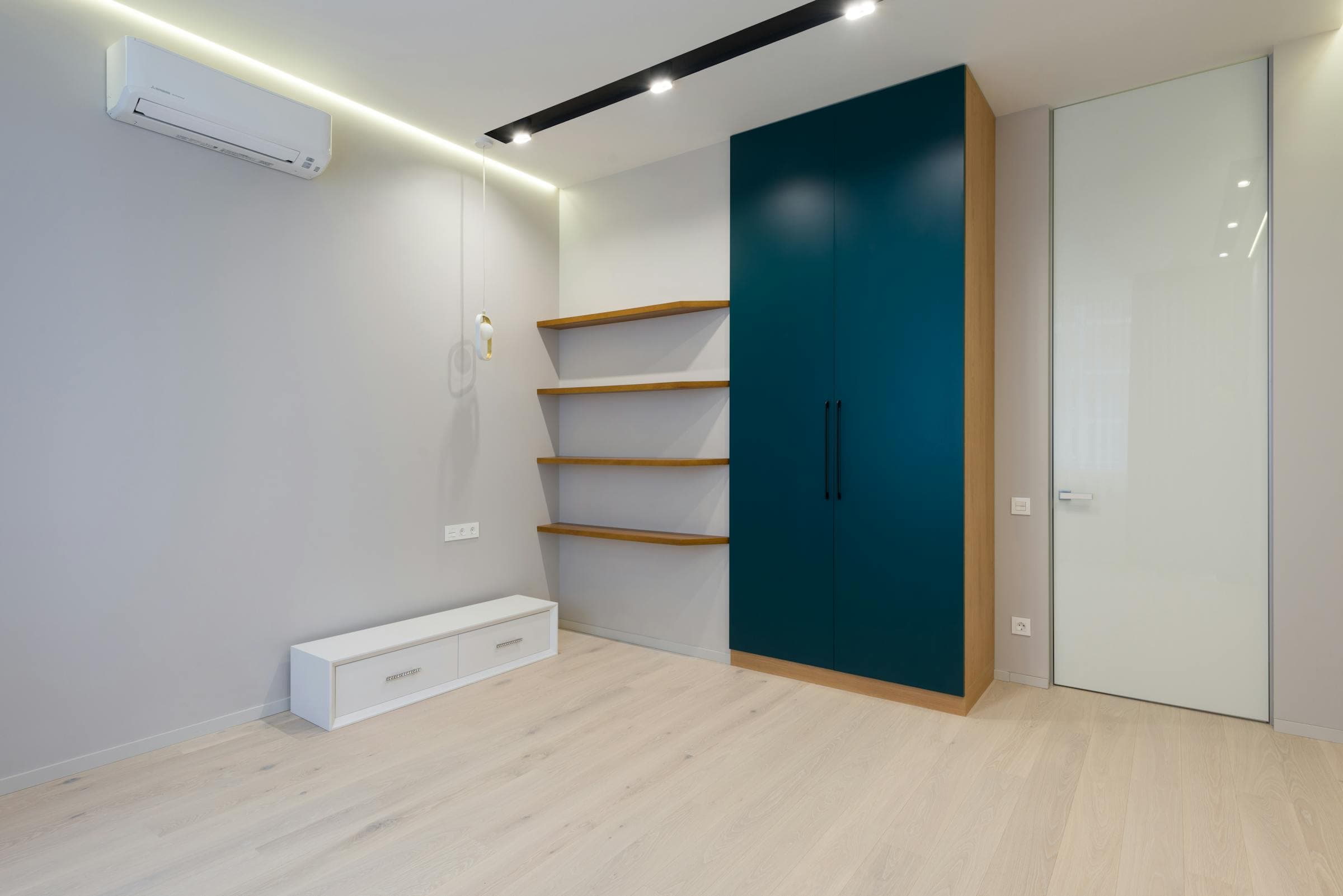 A calm interior corner with wooden cabinetry.